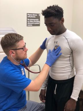 Dr. Stephen Graham performs a heart and lung check on Hammond High Magnet School football and track athlete Kevin Primus, 18. 